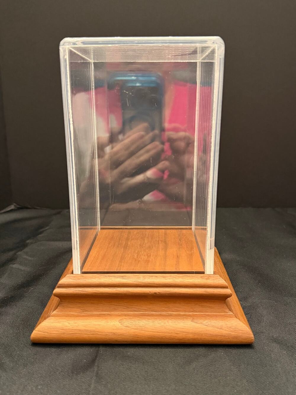 Clear UV acrylic display case a tiered hardwood base to showcase collectibles